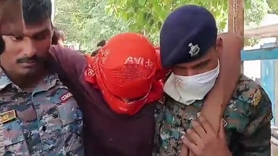 Security personnel carry an accused allegedly involved in the harassment of a boy and a girl by the roadside, after he was shot in leg during a police encounter, in Jamui, Bihar. (Hindustan Times)