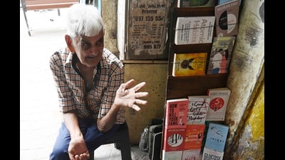 Mobin Beg, 80, sits at his book stall in Hazratganj where he has sold English paperback books for the past 40 years. (Deepak Gupta/HT)
