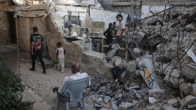 Displaced Palestinians gather amid the rubble of a heavily damaged building being used as a shelter in Khan Yunis in the southern Gaza Strip. (AFP) Displaced Palestinians gather amid the rubble of a heavily damaged building being used as a shelter in Khan Yunis in the southern Gaza Strip. (AFP)