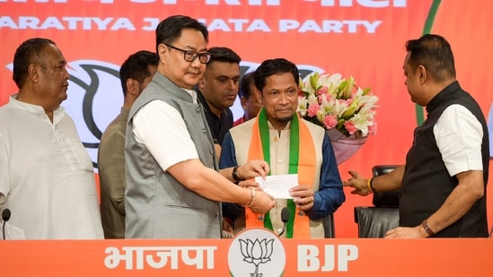 Union Minister of Parliamentary Affairs, Kiren Rijiju, presents the party membership slip to an MLA as Meghalaya's United Democratic Party (UDP). (Sathiya)