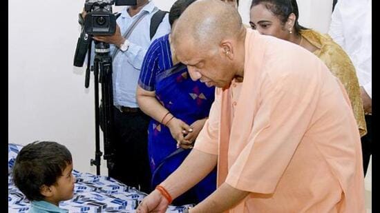 Chief minister Yogi Adityanath meets a child during the inauguration of a state women’s shelter, in Gorakhpur. ((@myogiadityanath/X via PTI Photo))