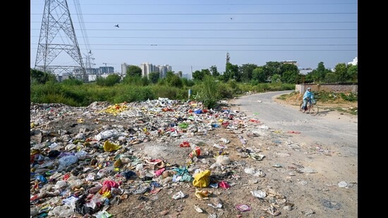 Illegally dumped garbage along the Sector-70A road near Pyramid Urban Homes housing society, as seen on Tuesday. (Parveen Kumar/Hindustan Times)