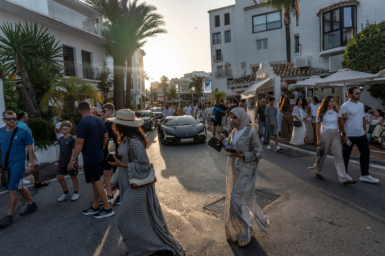 Visitors strolling in Puerto Banús, an exclusive neighborhood and marina in Marbella, Spain. Visitors strolling in Puerto Banús, an exclusive neighborhood and marina in Marbella, Spain.