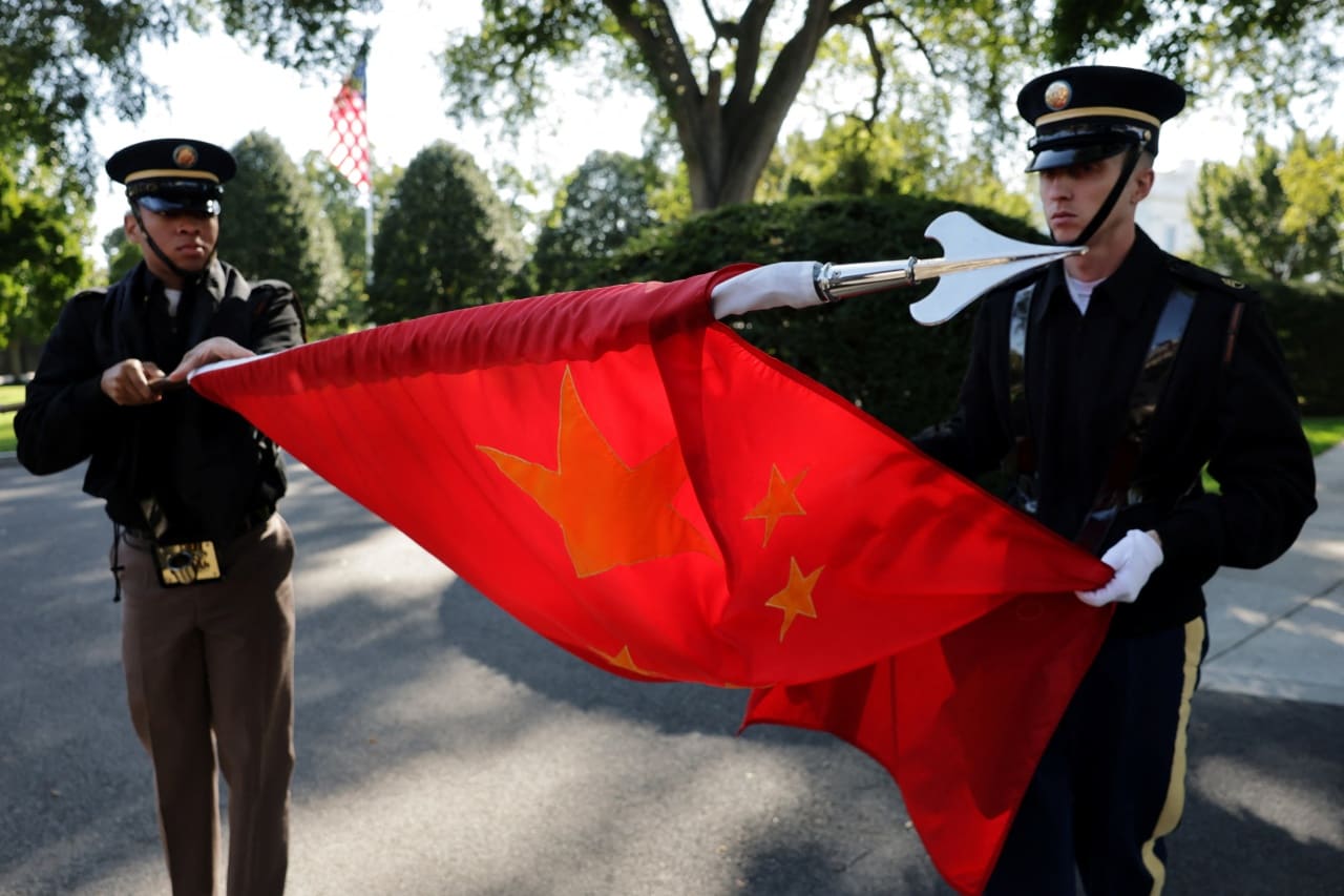Members of a U.S. military honor guard rolling up a Chinese flag after rehearsing for Xi’s state visit. Members of a U.S. military honor guard rolling up a Chinese flag after rehearsing for Xi’s state visit.
