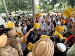 AAP activists staging a demonstration outside the GMADA office in Mohali on Thursday while ED officials were inside. (Ravi Kumar/HT)