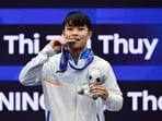 Roshibina Devi poses with her silver medal after winning in the women's 60kg Sanda category.
