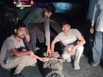 Dudhwa buffer zone forest staff rescuing a crocodile from a hutment in Dubaha village on Monday (HT Photo)