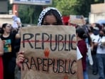 A college student holds a placard during a solidarity march demanding police action and better safety for women following the alleged gang rape of a girl.