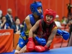 Naorem Roshibina Devi, blue, competes against China's Zhang Xiaoyu in the in the Women's 60kg Wushu match final during the 20th Asian Games