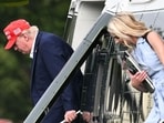 US President Donald Trump and aide Natalie Harp exit Marine One on the Ellipse near the White House on August 16.