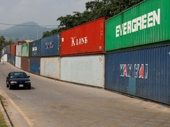 A vehicle moves past shipping containers used to block the area ahead of a planned march by former Pakistani Prime Minister Imran Khan's party, demanding his release and calling for the supremacy of the Constitution and restoration of the rule of law across the country, in Islamabad, Pakistan, September 23, 2026. REUTERS/Akhtar Soomro