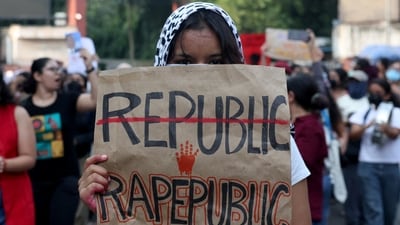 A college student holds a placard during a solidarity march demanding police action and better safety for women following the alleged gang rape of a girl. (REUTERS)