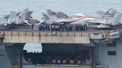 Personnel and aircraft on the deck of the US Navy Nimitz-class aircraft carrier USS Abraham Lincoln as it sails toward Laem Chabang Port . (REUTERS)