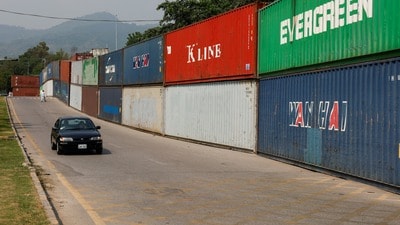 A vehicle moves past shipping containers used to block the area ahead of a planned march by former Pakistani Prime Minister Imran Khan's party, demanding his release and calling for the supremacy of the Constitution and restoration of the rule of law across the country, in Islamabad, Pakistan, September 23, 2026. REUTERS/Akhtar Soomro (REUTERS)