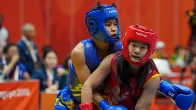 Naorem Roshibina Devi, blue, competes against China's Zhang Xiaoyu in the in the Women's 60kg Wushu match final during the 20th Asian Games (PTI) Naorem Roshibina Devi, blue, competes against China's Zhang Xiaoyu in the in the Women's 60kg Wushu match final during the 20th Asian Games (PTI)