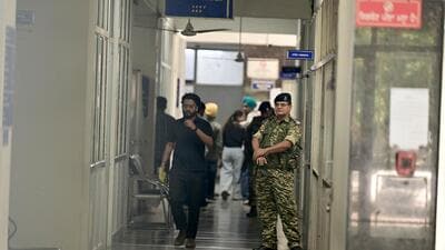 Security personnel standing guard during the Enforcement Directorate raid on the Greater Mohali Area Development Authority (GMADA) headquarters on Wednesday. (Ravi Kumar/HT)
