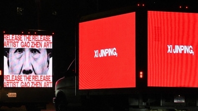 Messages for China's President Xi Jinping calling for the release of political prisoners from the Human Rights Foundation are displayed in trucks near the National Gallery of Art in Washington, DC. (AFP)