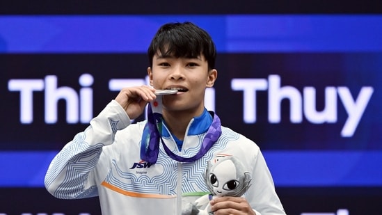 Roshibina Devi poses with her silver medal after winning in the women's 60kg Sanda category.
