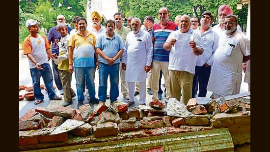 Members of Pakshi Sewa Samiti showing the demolished structures by MC in Rakh Bagh, in Ludhiana. (Gurpreet Singh/Hindustan Times)