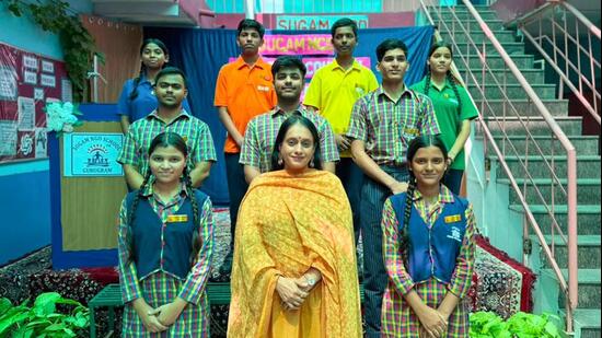 Monika Sharma of Sugam NGO with the students at her school in South City-1, in Gurugram, on Thursday. (HT Photo)
