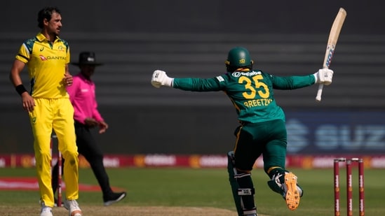 Matthew Breetzke celebrates his century off Australia's bowler Mitchell Starc.