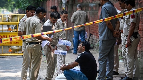 Police personnel investigate the site of an encounter at Amar Colony in southeast Delhi, India, on Tuesday. According to police, an accused identified as Asif, wanted in connection with the alleged sexual assault of a minor near Kalkaji Mandir, was arrested following an exchange of fire with police.