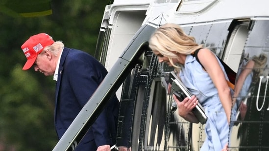 US President Donald Trump and aide Natalie Harp exit Marine One on the Ellipse near the White House on August 16.