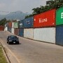 A vehicle moves past shipping containers used to block the area ahead of a planned march by former Pakistani Prime Minister Imran Khan's party, demanding his release and calling for the supremacy of the Constitution and restoration of the rule of law across the country, in Islamabad, Pakistan, September 23, 2026. REUTERS/Akhtar Soomro