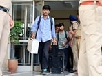 Enforcement Directorate officials leaving the GMADA office in Mohali on Thursday. (Ravi Kumar/HT)