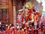 Devotees gather as the Lalbaugcha Raja idol begins its journey towards immersion in Mumbai.