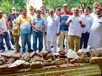 Members of Pakshi Sewa Samiti showing the demolished structures by MC in Rakh Bagh, in Ludhiana. (Gurpreet Singh/Hindustan Times)