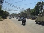 Officials said the road was badly damaged during the recent monsoon, while overflowing sewage from a nearby colony also led to the formation of large potholes. (HT Photo)
