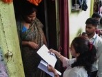 Voters provide information to SIR officials in Pune.