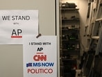 Flyers supporting the Associated Press, CNN, MS NOW and Politico hang inside of the White House briefing room in Washington, DC, on September 21, 2026. Three leading US news outlets announced on September 21 they will go to court after being banned from the White House, as President Donald Trump claimed that media critical of his administration is a 