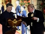 US President Donald Trump holds a binder as he stands next to Chinese President Xi Jinping before Xi delivers a speech during a state dinner at the White House in Washington, D.C., US, September 24, 2026. 