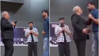 As seen a video now going viral, the visibly irked professor called the student on stage and grabbed him by the collar. (Screengrab from X)