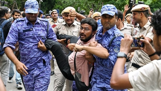 Jantar Mantar news: Security personnel detain an All India Students' Association (AISA) member during a protest against CEC Gyanesh Kumar outside Jantar Mantar, in New Delhi.