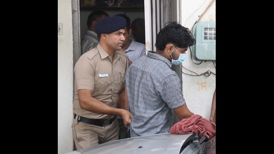 The accused being taken away by the police from his residence in Sector 22, Chandigarh, on Friday. (Keshav Singh/HT)
