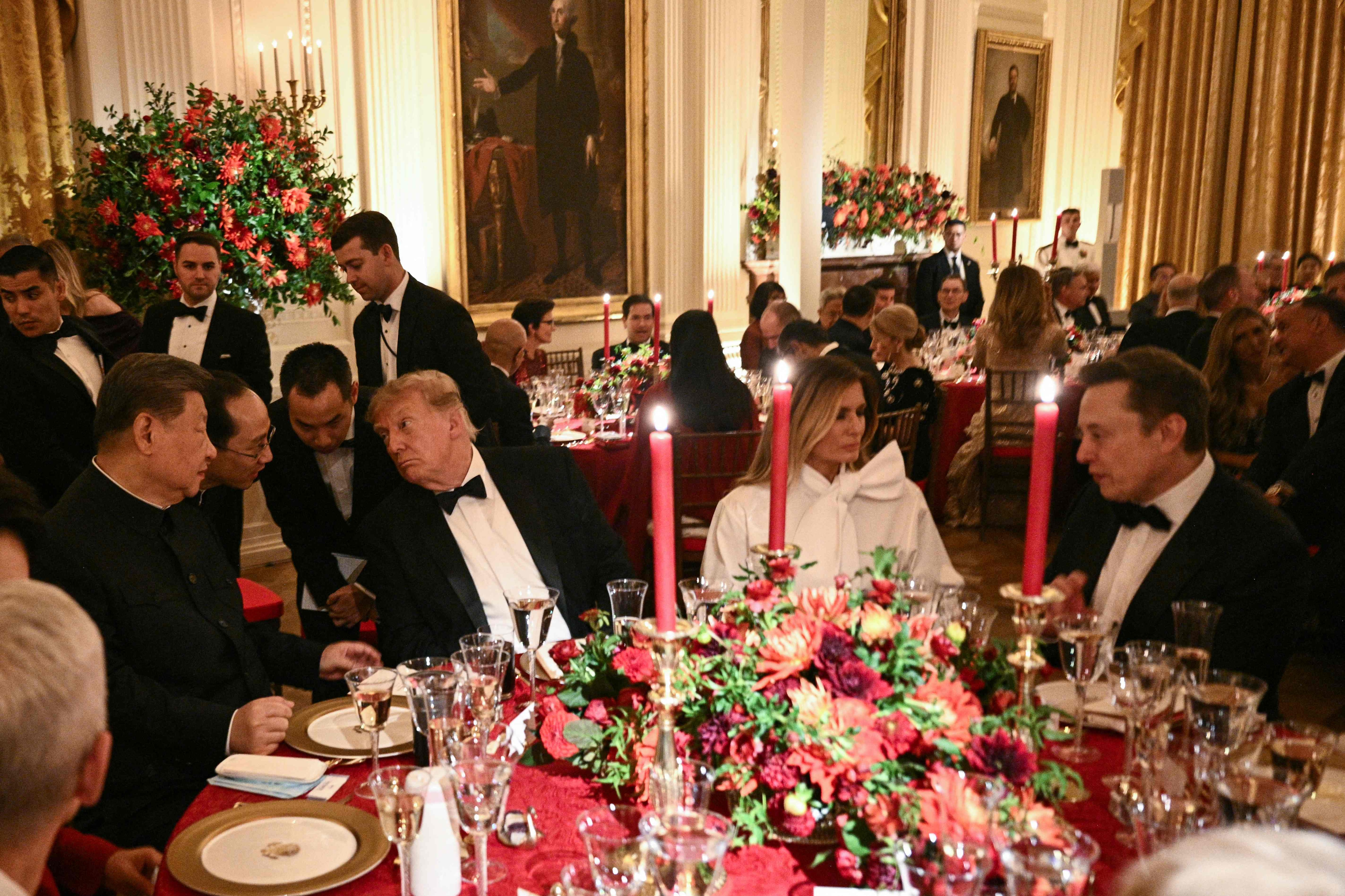 China's President Xi Jinping (L) and US President Donald Trump speak through interpreters as First Lady Melania Trump listens to Tesla CEO Elon Musk during a State Dinner in the East Room of the White House in Washington, DC. (AFP) China's President Xi Jinping (L) and US President Donald Trump speak through interpreters as First Lady Melania Trump listens to Tesla CEO Elon Musk during a State Dinner in the East Room of the White House in Washington, DC. (AFP)