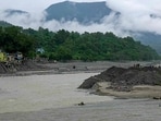 People cross the Trishuli River via a zip line in the aftermath of the flash flood. 