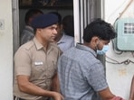 The accused being taken away by the police from his residence in Sector 22, Chandigarh, on Friday. (Keshav Singh/HT)