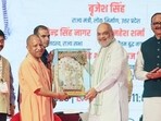 Union home and cooperation minister Amit Shah being felicitated by chief minister Yogi Adityanath at the fourth edition of the UP International Trade Show (UPITS 2026) at the India Expo Centre and Mart, in Greater Noida on Friday. Deputy chief minister Brajesh Pathak and UP cabinet minister Nand Gopal Gupta Nandi also present. (ANI PHOTO)