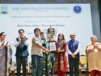 Vice-President CP Radhakrishnan (centre) presents awards to winners of the 3rd Arun Jaitley Memorial Debate at Shri Ram College of Commerce in New Delhi on Friday. (X/@VPIndia)