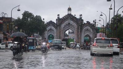 Commuters negotiate a waterlogged road in Old Lucknow on Saturday. (Deepak Gupta/HT Photo)
