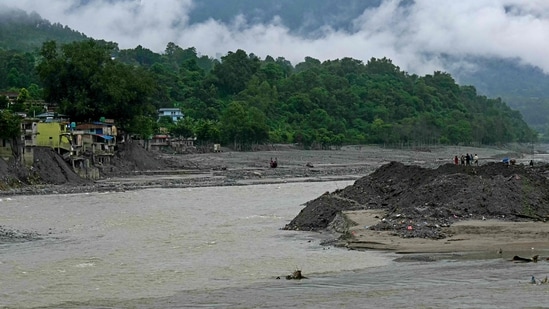 People cross the Trishuli River via a zip line in the aftermath of the flash flood. (File Photo/AFP)