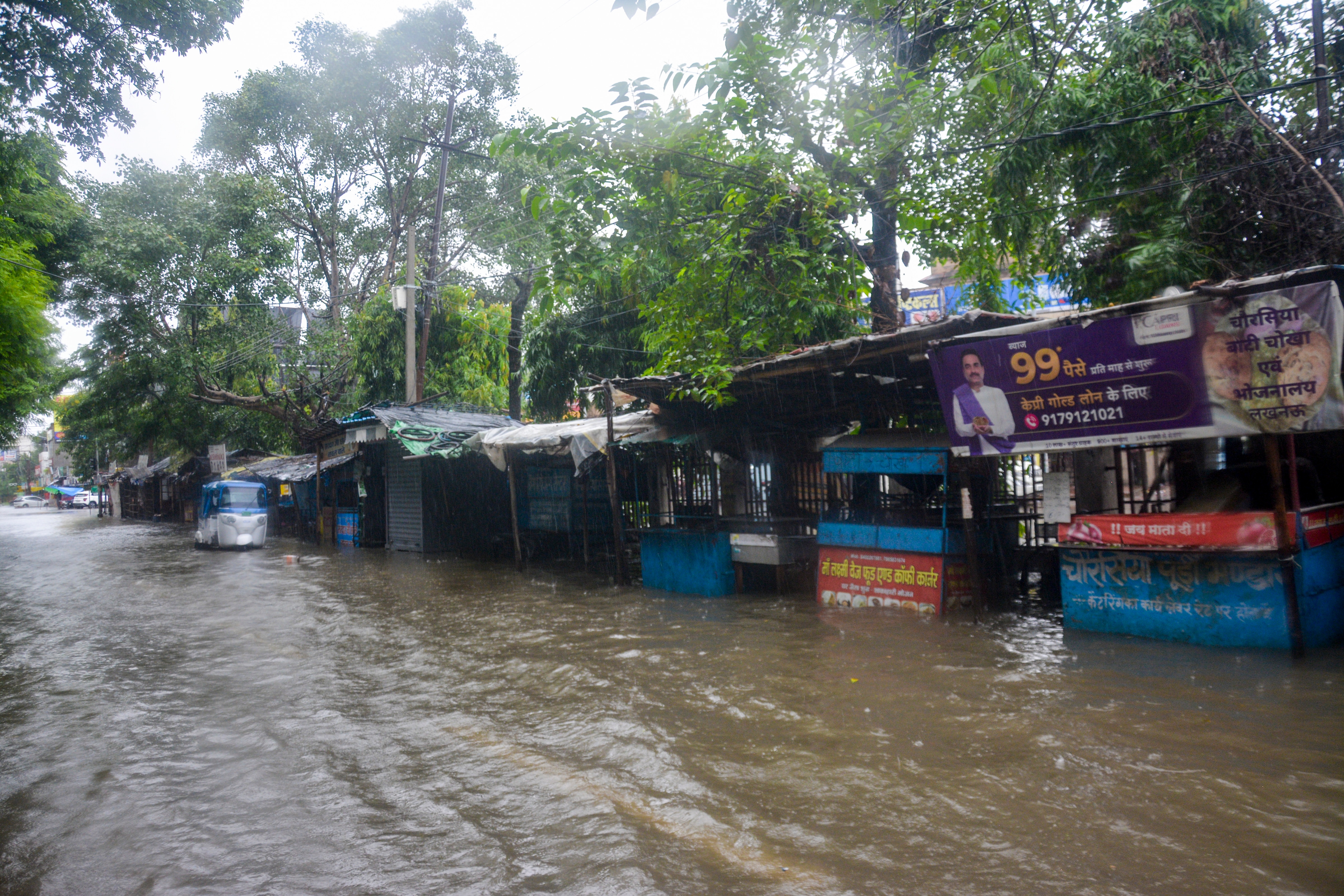 An auto-rickshaw moves through a waterlogged road amid rainfall, in Lucknow, Uttar Pradesh, Saturday, Sept. 26. (PTI) An auto-rickshaw moves through a waterlogged road amid rainfall, in Lucknow, Uttar Pradesh, Saturday, Sept. 26. (PTI)