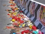 Footwear and other belongings of people lie on a road in the aftermath of a stampede during a rally of TVK chief Vijay, in Karur district. 