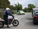 Police blocked a road while posted outside RAF Fairford base in Fairford, south-west England on September 27, 2026, as UK counter-terrorism police investigate an incident near the base in the village of Whelford.