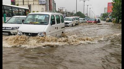 Commuters wade through a waterlogged road following heavy rainfall at Ashiana Colony, in Lucknow on Saturday. (ANI) Commuters wade through a waterlogged road following heavy rainfall at Ashiana Colony, in Lucknow on Saturday. (ANI)
