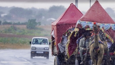 People travel in camel carts amid rainfall at Pushkar, in Ajmer district, Rajasthan. (Representative Image/PTI) People travel in camel carts amid rainfall at Pushkar, in Ajmer district, Rajasthan. (Representative Image/PTI)